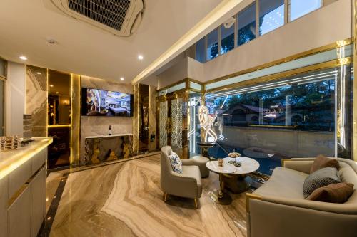 a living room with a couch and chairs and a table at H A O Boutique Hotel in Ho Chi Minh City