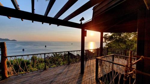 a view of the ocean from the porch of a house at Koh Tao Cabana in Koh Tao