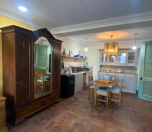 a kitchen with a table and chairs and a dining room at Constantia View Apartments- Luxury Self Catering in Cape Town