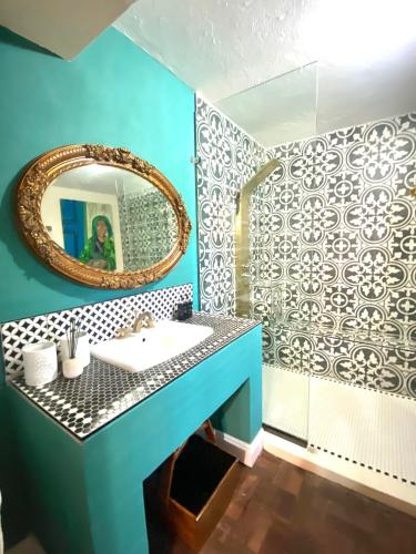 a bathroom with a sink and a mirror at Constantia View Apartments- Luxury Self Catering in Cape Town