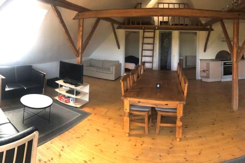 a large living room with a wooden table and chairs at Schou Lykke Nord in Tarm