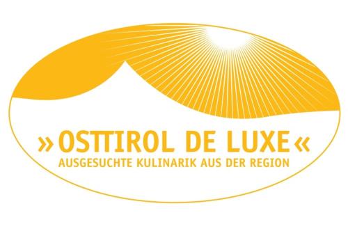 a logo for a museum of music with a yellow ribbon at Hotel Gesser in Sillian