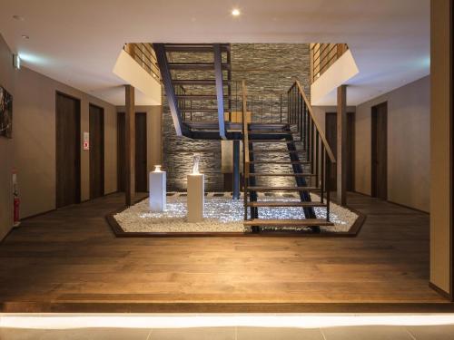 a lobby with a spiral staircase with two candles at Panorama Niseko in Kutchan