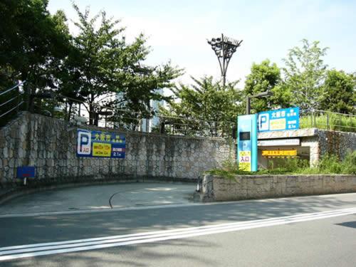 a road with a wall and signs on the side of it at Hotel Sunlife in Osaka