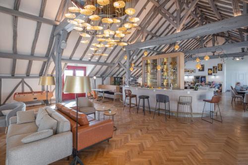 a living room with a couch and a bar at La Clef des Ch&acirc;teaux in Maslives