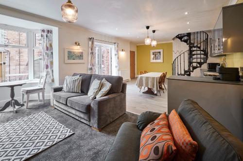 a living room with a couch and a table at Host & Stay - The Courtyard at No.47 in Scarborough