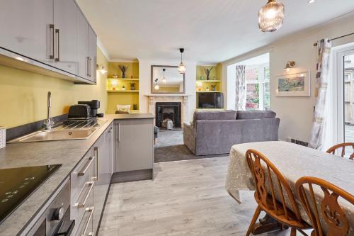 a kitchen and living room with a table and a couch at Host & Stay - The Courtyard at No.47 in Scarborough