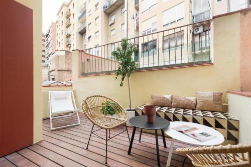 a balcony with a table and chairs on a building at Olala Diagonal Apartments in Barcelona