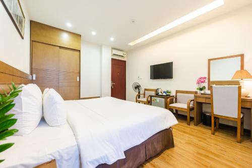 Habitación de hotel con cama, escritorio y ordenador en One Hotel en Hanoi