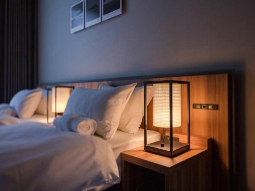 a bedroom with a bed and a lamp on a table at Panorama Niseko in Kutchan