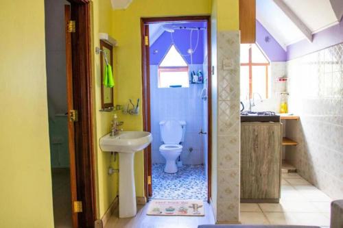 a bathroom with a toilet and a sink at Charming 1-Bed Penthouse in Karen Nairobi in Nairobi