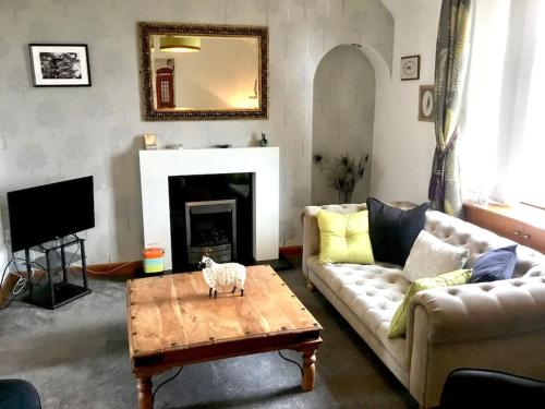 a living room with a couch and a table at Bonnie Bide Huntly Aberdeenshire in Huntly