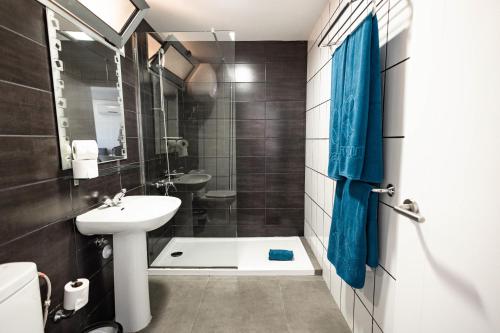 a bathroom with a sink and a toilet and a shower at Servatur Castillo de Sol in Puerto Rico de Gran Canaria