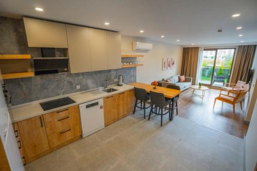 a kitchen and living room with a table and chairs at LARA MARİNE HOMES in Antalya