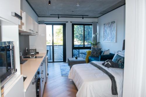 a bedroom with a bed and a living room at 101 Bridgewater Apartment in Cape Town