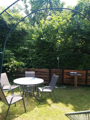 a table and chairs in a backyard with an arbor at CHILL&SLEEP Bad Ischl in Bad Ischl