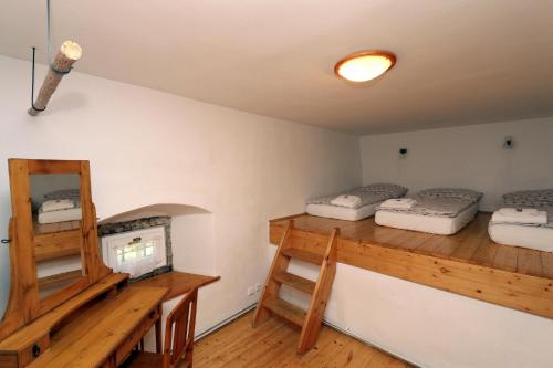 a room with two bunk beds and a fireplace at Penzion Mauritz in Nová Pec
