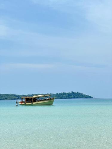 a boat sitting in the middle of the water at Seacret KohKood เกาะกูด in Ban Lak Uan