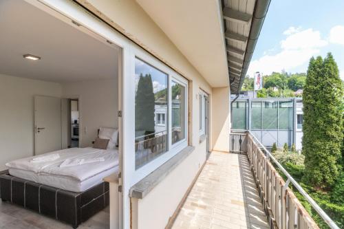 a balcony with a bed and a window at Unique: Geräumige 4 Zimmerwohnung in Tuttlingen mit Sauna, Fitness und Netflix OG in Tuttlingen