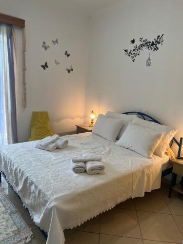 a bedroom with a bed with towels on it at Faidra's House in Lefkada