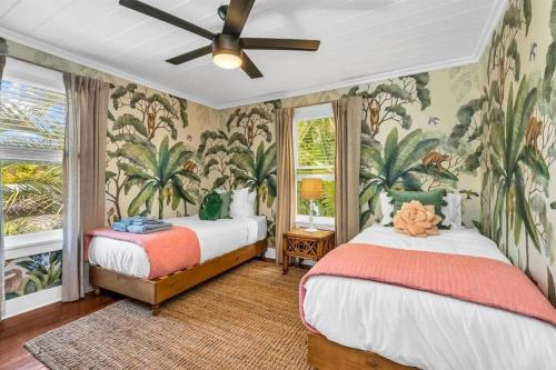 a bedroom with two beds and a ceiling fan at Tropical Estate w/ Guesthouse & Pool. Sleeps 8! in West Palm Beach