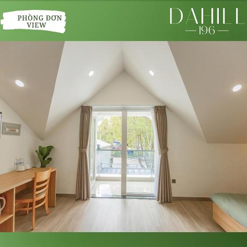 a living room with a table and a window at Dahill 196 Dalat in Da Lat