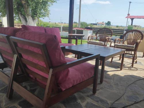 a couch and a table and chairs on a patio at Kalliopi's House in Aroyí