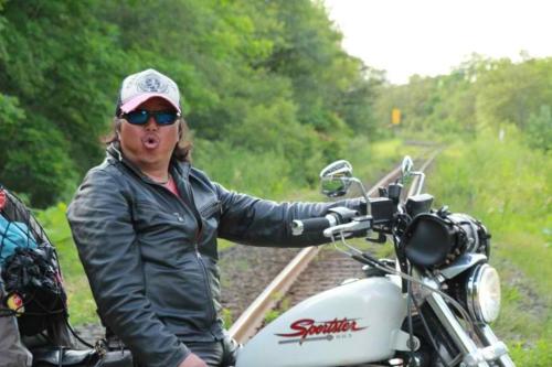a man sitting on a motorcycle on the tracks at Kakureyado Fujikawaguchiko in Fujikawaguchiko