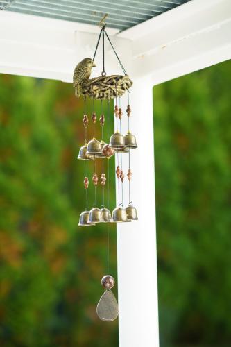 a bird perched on a bird feeder on a porch at Kakureyado Fujikawaguchiko in Fujikawaguchiko