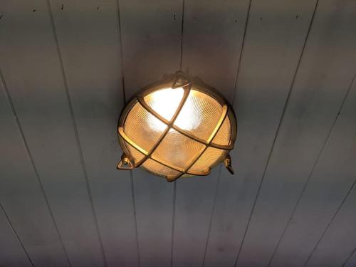a light fixture hanging from a ceiling at Kenny’s Hut in Cowfold