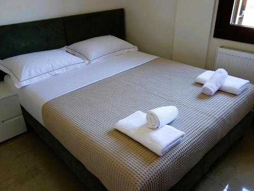 a bedroom with a bed with towels on it at Blue Dream Villa in Nea Skioni