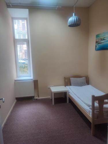 a small bedroom with a bed and a window at Hostel Best time in Lviv