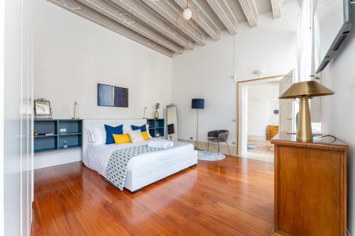 a bedroom with a white bed and a wooden floor at [2 minutes walk from Verona Arena]Luxury Apartment in Verona