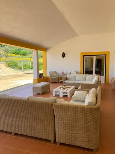 a living room with two couches and a table at Casa do Alfaro in Azambuja