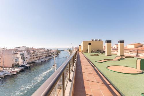 a balcony with a view of a river and buildings at Pierre & Vacances Empuriabrava Marina in Empuriabrava