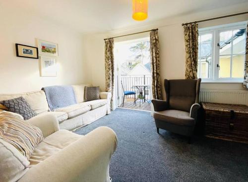 a living room with a couch and a chair and a window at Centrally located "Spring Cottage" Perfect Ventnor Holiday Home in Ventnor