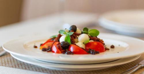 a plate of food on a table at Oak Leaf Residences in Budva
