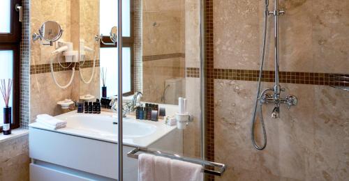 a bathroom with a sink and a shower at Oak Leaf Residences in Budva