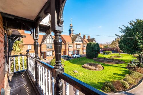 a view from a balcony of a house with a yard at The Windsor Tapestries Retreat - Sleeps up to 9, Hot Tub, Free Parking, Dog Friendly in Windsor
