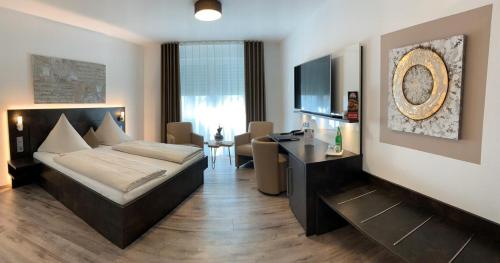 a bedroom with a bed and a desk in a room at Campushotel in Hagen