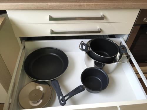 two pots and pans sitting on a kitchen counter at Holiday Apartment in Oberveischede