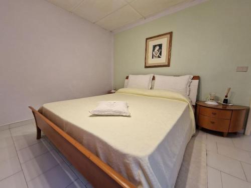 a bedroom with a large bed and a night stand at La casetta di Flo in Montecosaro