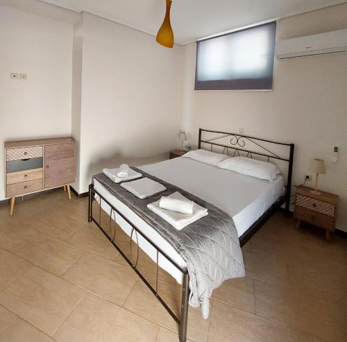 a bedroom with a bed and a dresser and a window at Golden Sunrise in Gythio