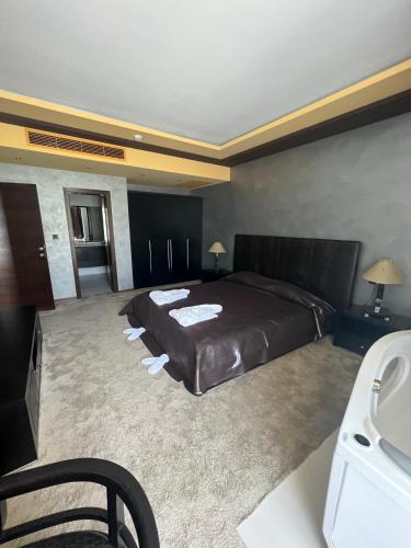 a bedroom with a large bed and a sink at Garden of Eden Complex in Sveti Vlas