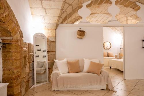 a living room with a white couch in a room at Leondari Rooms V Collection Otranto in Otranto