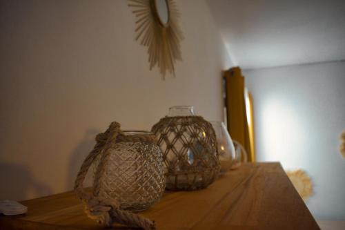 a wooden table with two vases on top of it at Casa Babalahy in Saint-Pierre