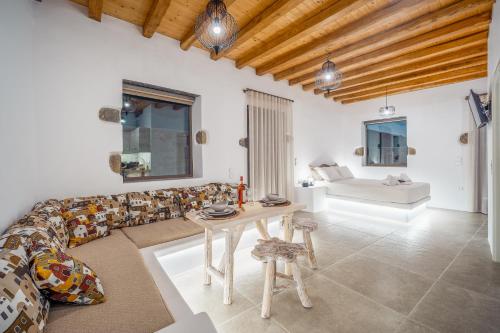 a living room with a couch and a table at Petrias Pool House in Serifos Chora