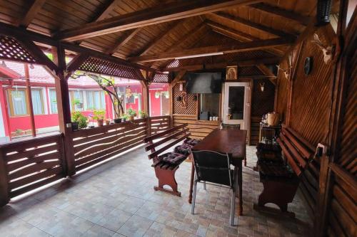 a wooden patio with a table and chairs in a house at Casa in Oradea ! in Oradea