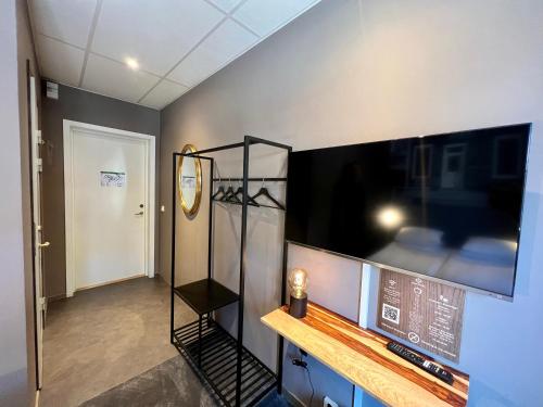 a room with a large flat screen tv on a wall at Hotell Siesta in Karlskrona