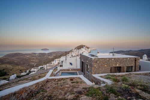 a house on a hill with a view of the ocean at Petrias Pool House in Serifos Chora